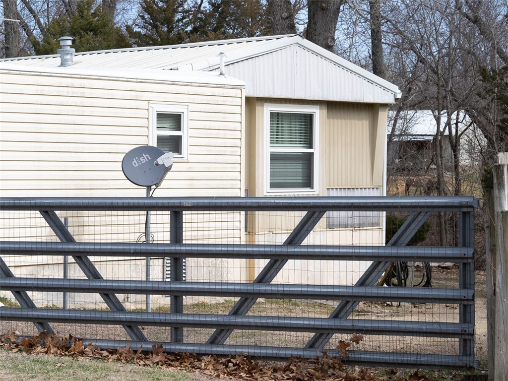 Here is your chance to own a nice single wide and addition on one acre of flat ground between Avoca and Garfield right off HWY 62. Four Bedrooms and two bathrooms, very nice Lennox wood stove in the great room. Space for your whole family with an RV barn for all your toys and tools, and detached carport for any extra vehicles. Detached Garage has a woodstove and a window unit AC. Enjoy the outside shed for lawn tool storage. Nice level land! Less than 15 minutes to Rogers, and 15 minutes to Beaver lake to fish, swim or play.
