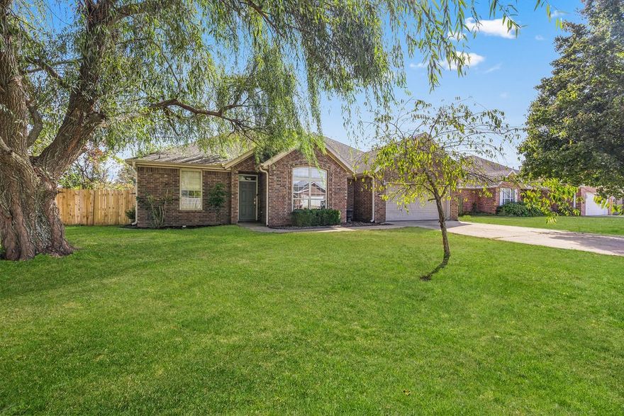 Stunning home in the Prairie Meadows Subdivision! Move-in-ready home features a bright, open-concept layout highlighted by vaulted ceilings and a cozy gas-log fireplace. Delightful eat-in kitchen boasting custom cabinetry, a center island, a stylish tiled backsplash and charming dining area. Recent upgrades include a brand-new roof, fresh neutral paint throughout, and plush new carpeting. Thoughtful split-bedroom floorplan ensures privacy, while the separate laundry room adds daily convenience. Enjoy your evenings on the covered patio overlooking a fully fenced backyard—perfect for play and relaxation. Located in the heart of Prairie Grove, you’re just a short walk from the Aquatic Park, Delford Reiff Park, schools, and local dining. Claim this beauty as yours today!