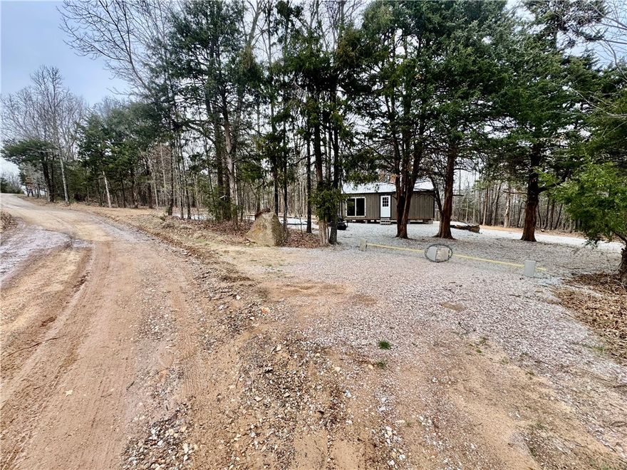 Recreational property near Kingston, AR with road access, electric, and high speed internet. Features hardwood timber, gently sloping terrain, and a newer unfinished cabin wired and plumbed with septic and water storage. Located near Boxley Valley and minutes to the Kings River. Wildlife in the area includes deer, bear, turkey, and elk.