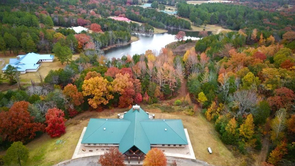 Escape to the Ozarks with this rare opportunity to own 218 acres of natural beauty at Lost Trails Ranch. This turnkey property blends serene wilderness with modern comfort, featuring miles of private trails, a spring-fed lake, creeks, and a stunning waterfall. The ranch includes four fully equipped lodges—Fireside, Foothills, Foxhaven, and Bearclaw Lodge. It also features a administrative building and gym with a stage area. Designed for both personal enjoyment and income potential, it’s ideal for weddings, retreats, and events. Recreation abounds with hiking, biking, kayaking, and wildlife watching across varied terrain from pine forests to open meadows. Outdoor living areas, firepits, and large dining spaces make it perfect for gatherings. Located near Mulberry and within 2 hours of major airports, Lost Trails Ranch offers seclusion with accessibility. Whether you're looking for a private escape, a retreat center, or an investment, this property delivers. Visit losttrailsranch.com to learn more.