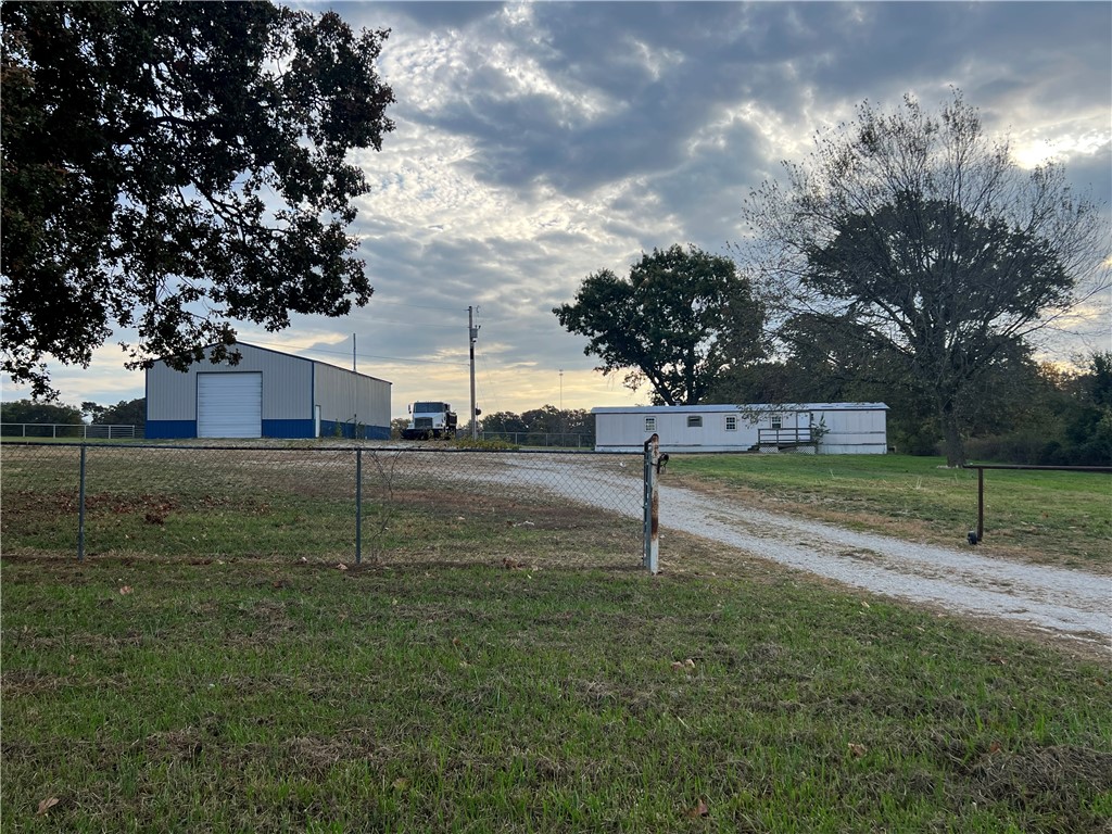 Rare 1.5 acres with 36' x 60' steel shop with concrete floors, electricity and water. Shop has 2 overhead doors for easy access and a wood burning stove for those chilly days you are working inside. There's also a 2 bedroom 2 bath mobile home that could be rented for additional income. Start your business or build your new home. Come check it out!