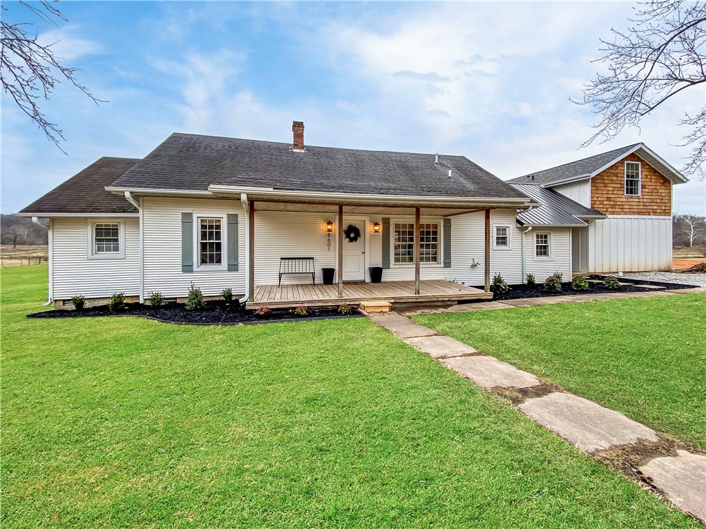 Located in Bentonville Schools! Check out this completely remodeled 1920 farmhouse located inside the Bentonville School district. This one of a kind home sits on a serene 1.34 acres alongside a spring fed stream only 3 miles from I-49. Remodeled with it's original character in mind, you will find shiplap walls, and exposed wood ceilings in many areas. Enjoy the best of 2020 in a piece of Northwest Arkansas history! Home also includes a 24'X48' detached shop building on concrete slab with pass-through garage doors.