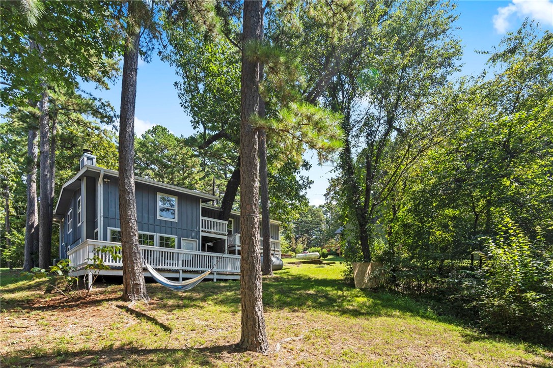 BRAND NEW ROOF August 2025. Sold fully furnished. This property is conveniently located near the trails, lakes and golf courses that make Bella Vista so desirable. The main floor was fully renovated in 2021, which includes the kitchen, living room, 2 bedrooms and 1 full bathroom. The basement was partially renovated and includes a second living room, 1 bedroom, 1 full bathroom, huge laundry room and extra storage. Three decks on the back provide a peaceful place to sit and enjoy the surrounding nature. The spacious eat-in kitchen was completely remodeled in 2021 with new cabinets, stainless steel appliances, quartz countertops and plenty of storage. The primary bedroom has a walk-in-closet and an extra space that can be used as an office, sitting area, nursery, etc. Plus, it has its own door leading out to the back decks. The open living area features an electric fireplace and a nook/flex space across from the entrance. A new A/C unit was installed in 2021.