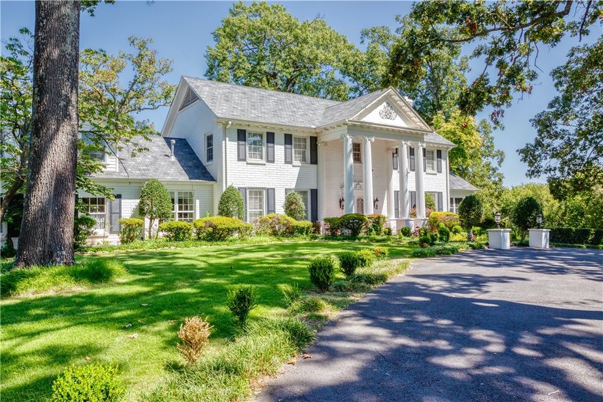 This beautiful estate has been preserved with care and updated with respect, offering the perfect blend of Southern charm, architectural integrity, and modern comfort. The curb appeal is unparalleled with stately columns, circular drive, mature oak trees, and a classic white picket fence which frames the front of the property. Nearly 5,600 Square feet on 3.35 acres overlooking the Arkansas River. There are two primary suites, with one being on the main floor, two large living areas, formal dining, office, and a bonus room. The open kitchen is equipped with vintage-inspired appliances, custom cabinetry, and modern quartz counters blending old world beauty with current functionality. There's a total of 4 garage spaces, 2 attached and 2 detached, connected with a covered porte-cochere. Out back is an inground swimming pool with manicured garden areas and open space ideal for enjoying the river views.