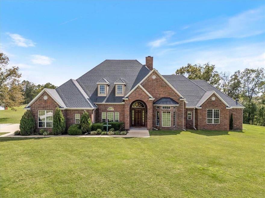 Welcome to this stunning 4-bedroom, 3.5-bath all brick, one-level home, tucked away on 5 serene acres in the highly sought after Forest Hills Subdivision. Boasting 3,975 square feet of thoughtfully designed living space, this estate offers the perfect balance of luxury and functionality. Step inside to a spacious and inviting floor plan featuring multiple living and dining areas, a large kitchen, and generously sized bedrooms, ideal for families and entertaining. Luxury items like the wood burning fireplace, the central vac system, his and her primary bath, private office space and wet-bar off the living room, make this home one of a kind. The property also includes a 60x40 large workshop, offering endless possibilities for hobbies and storage space. With 5 acres of open and wooded land, there's plenty of room for recreation, gardening, animals, or even future expansion. Located just minutes from Siloam Springs and convenient to shopping, dining, and schools, this is country living without sacrificing convenience.