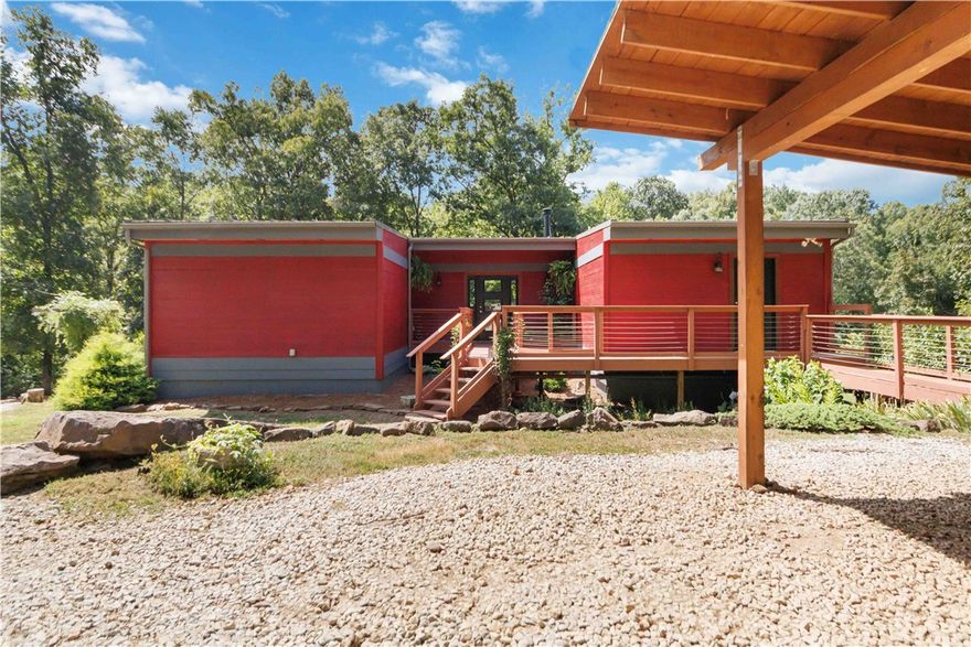 This custom modern retreat blends luxury, privacy, and thoughtful design on 27.15 acres with creek and mountain views. The home offers 4 bedrooms, 3 bathrooms, a bonus room, and flexible storage or office space in a functional layout. Interior highlights include granite countertops, a whirlpool tub, and a primary suite with dual rain shower heads and large walk-in closets. 
Outdoor features include a semi-inground pool, raised-bed garden, custom native rock wall, mobile chicken coop, and fruit trees including pear, apple, plum, peach, pawpaw, blackberry, blueberry, and grapevine. The peaceful setting offers wildlife and established deer trails. 
Designed for efficiency and durability, the home includes Daikin mini-split HVAC, spray-foam insulation, mostly south-facing Pella windows and doors, passive ventilation, a wood-burning stove, and an industrial-grade standing-seam metal roof. A two-car carport with storage shed completes this exceptional property near Devil’s Den State Park and the Buckhorn Trail System.