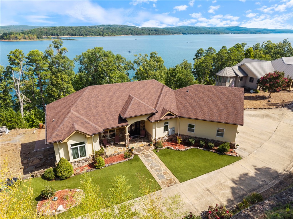 Welcome to your dream retreat on beautiful Greers Ferry Lake in Bee Branch! This luxurious lakefront home is filled with warmth, character, and high-end finishesāfrom inlaid floors to custom cherry wood trim, and cabinetry. The open floor plan offers bright, spacious living with breathtaking lake views from nearly every room. A sweeping staircase connects two inviting living areas, each with its own fireplace. Enjoy movie nights in the theater room and host with ease in multiple entertainment spaces. The walk-out basement opens to a large patioāperfect for lakeside gatherings and sunsets. A gourmet kitchen with generous pantry makes entertaining effortless, while the built-in tornado/storage room provides peace of mind. Nearby boat launch and storage make lake life easyābring your boat, jet skis, and water toys! Just 20 minutes from Sugar Loaf Park and Hwy 65. 2x6 construction, spray foam insulation, new roof 2025, newer DW & fridge, oversized 2-car garage (700+ sqft). Lake living at its finest.