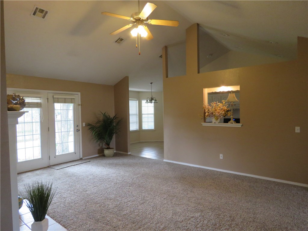 Spacious inmaculate home with new carpet in established neighborhood and fantastic location near community center, playground, groceries store, tennis courts and schools. Home boasts vaulted ceiling, open split floor plan, a convenient practical room that can be a studio or a family room, a nice shady backyard with extended patio, front porch, mature trees, freshly updated cabinets, and a jetted tub. Additionally a 2-10 home warranty is included. Ready to move in!