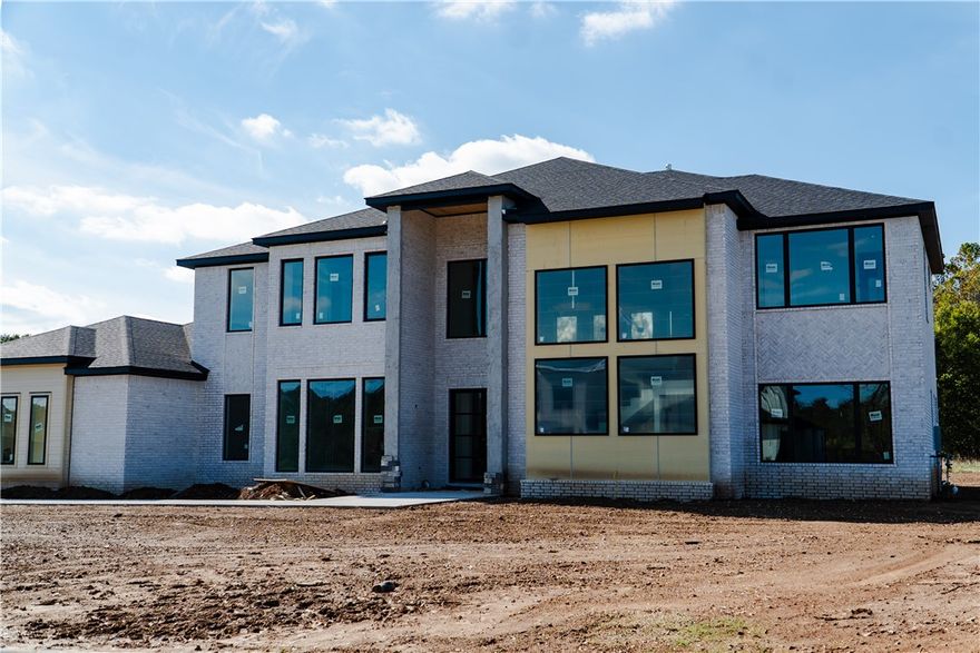 There is absolutely nothing like this property in all of Northwest Arkansas! This gorgeous new home sits on 1 acre with the Arkansas Natural Heritage Preserve and Stillhouse Spring Creek right behind for max privacy. The custom features in this elevated design mean form won't ever take a backseat to function. The heart of the home is a true chef’s kitchen with expansive island, custom cabinetry, and seamless flow into the living areas—perfect for entertaining or everyday luxury. Work from home in the dedicated home office, or unwind in the versatile bonus room complete with a full wet bar for effortless gatherings. Retreat to privacy with all en-suite bedrooms plus two convenient half baths for guests. The crown jewel? A massive covered patio spanning the rear of the home, ideal for year-round al fresco dining, lounging, or hosting under the stars. Natural amenities include waterfalls, springs, ponds, and access to Little Osage and Stillhouse Spring creeks. Call for complete list of features! Bentonville schools!