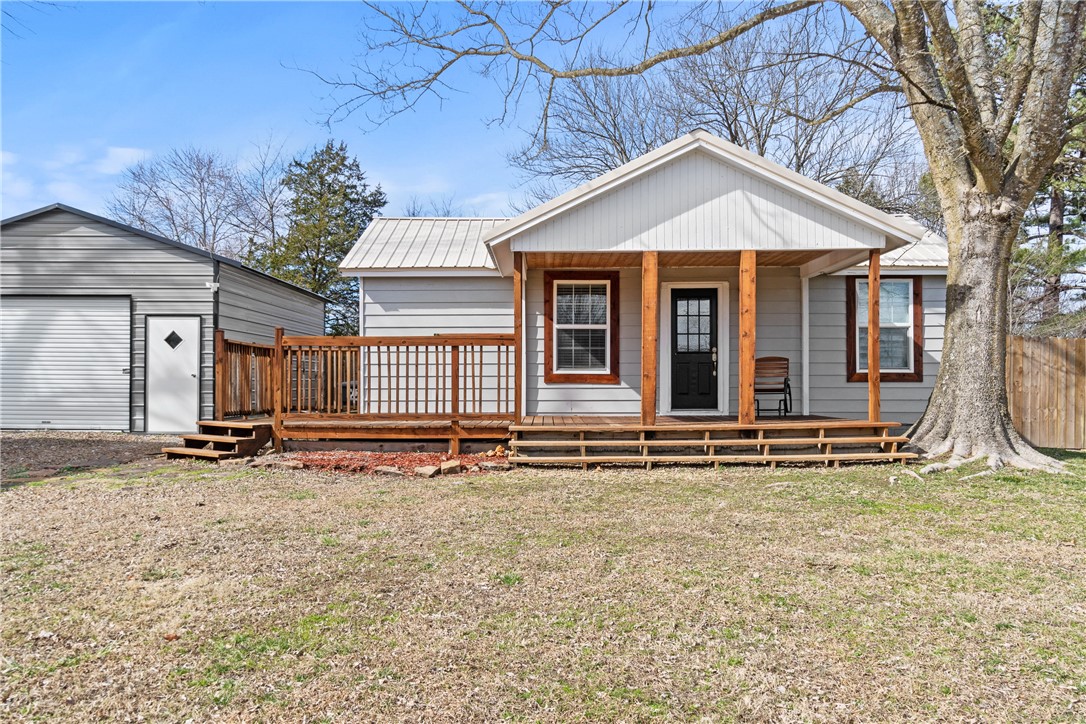 Charming cottage with lots of updates including a metal roof in 2023. The seller leveled the floor since purchase, however house needs some work. Seller selling as is be sure and put in offer. No fha or va. Cozy home with a great shop/garage perfect for projects and there is a nice shed in the back yard. Level large lot with room for a garden and much more. Still, some TLC is needed but shows well. This one is in the heart of town with easy access to Fayetteville, U of A, and more.