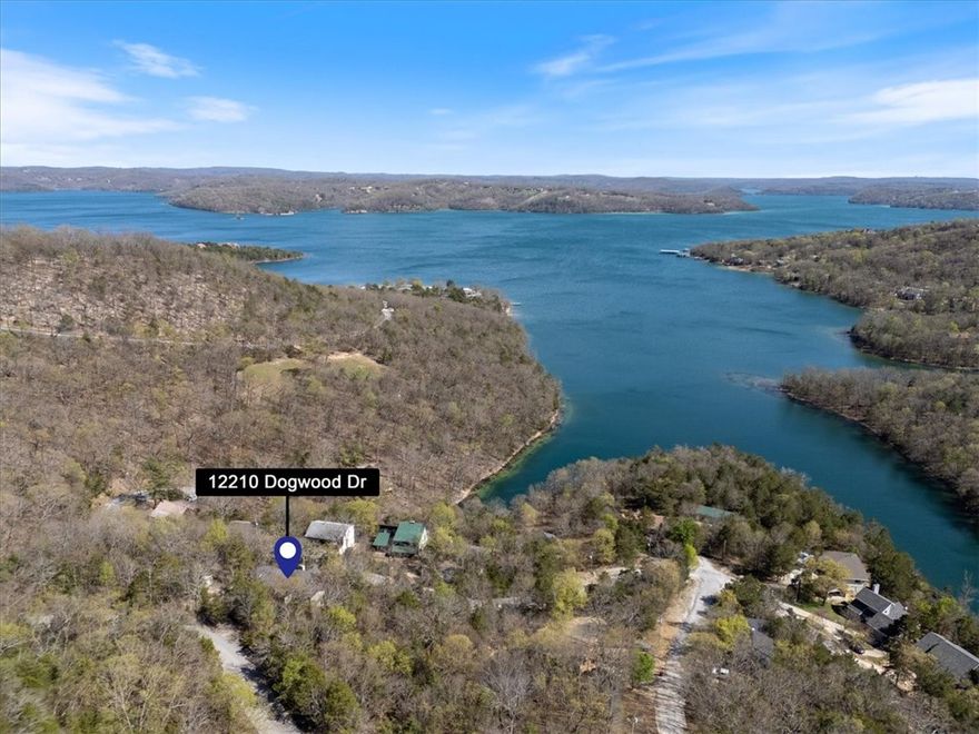 Lake View Living at Its Finest–Fully Furnished & Turn-Key! 4 Bed|3 Bath|Sleeps 12|Stunning Views|Vacation Rental Potential: Big views & bigger memories await at this charming lake view home, perfectly suited for a large family or an ideal vacation rental investment. This spacious 4-bd, 3-bath property offers room to relax & play—w/ sleeping accommodations for up to 12! Inside, you'll find an open-concept kitchen & dining area, complete with hardwood floors & a cozy fireplace. The sunroom on the upper level features panoramic lake views, a daybed, & a sleeper sofa—perfect for sunrise coffees or extra guests. The lower-level family room is ready for fun w/ two sets of bunk beds, a pool table,& a comfy sectional sofa—a great hangout spot for kids or groups.
Step outside to enjoy the partially covered deck, ideal for outdoor dining, or let your pup run free in the fenced backyard. This home comes fully furnished—rare turn-key opportunity. Link for info on Lost Bridge Village: http://lbvca.com/. Deck is being repaired