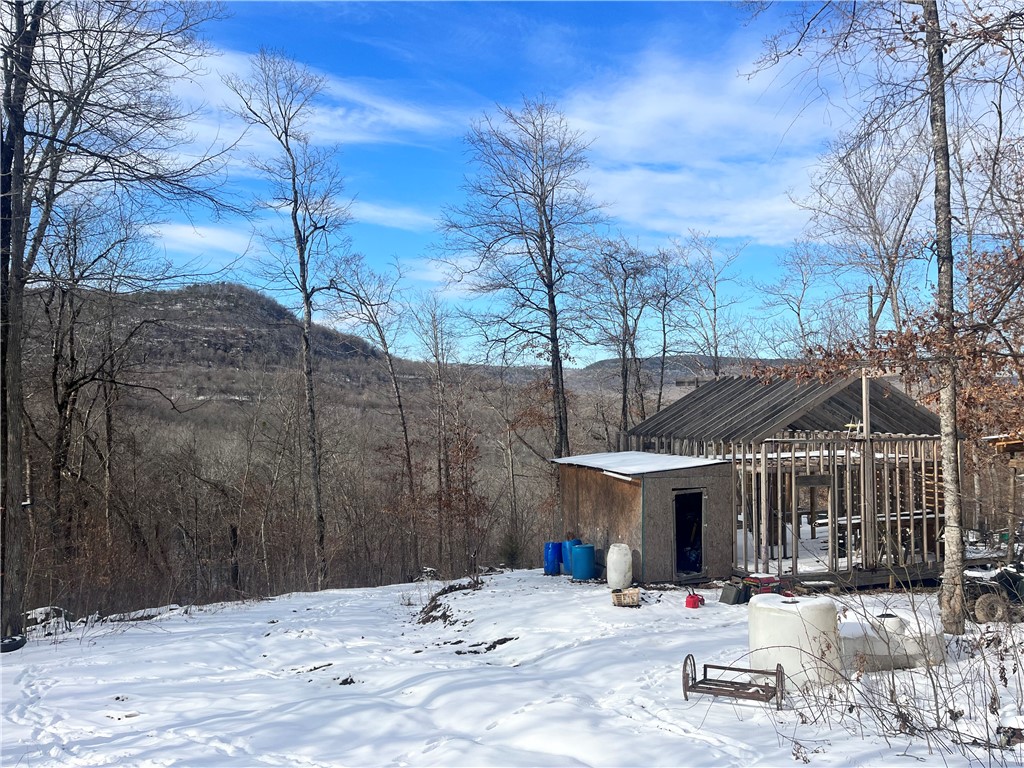 12.22 Acres with a framed 640 sq ft unfinished cabin located just outside of Jasper in beautiful Newton County, Arkansas. This property also comes with a skyline Aljo travel trailer with carport. Sitting toward the top of the mountain, with a little clearing you would have spectacular views of the valley below. There is also multiple other building sites along the county road with potential for great views. Electric is just a few feet from the property. There is multiple springs as well as ATV trails already in place. Close to the Buffalo National River and Ozark National forest.