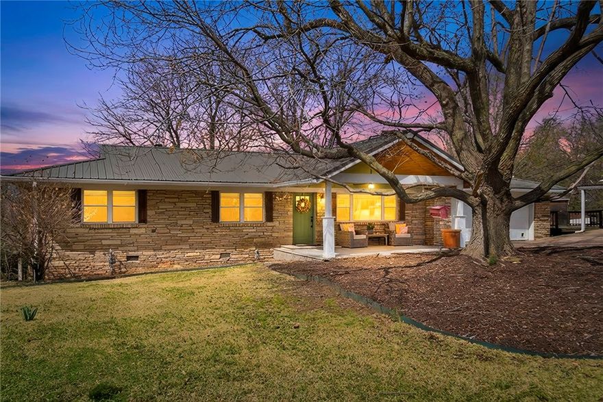 Give me LAND lots of land under STARRY SKIES above! She's a one of kind BEAUTY. The UNICORN. A place to DREAM BIG & LIVE simply but still get to Starbucks in 5 minutes. 5 miles to UofA & HOGS games. This 10.14 acre hobby farm offers it all - a completely REIMAGINED 1967 native stone ranch home with back porch sunsets, front porch rocking, BBQs, drink sipping, campfires, ATV riding, hammock & tree swinging. Want Chickens? A 2nd dream home site? Dog yard? Bike & Gear storage? Workshop? She's got 'em all! Raise some COWS, DIG in the dirt, PLANT your garden, ENJOY outside! COZY up by the woodburning Fireplace, SAVOR a meal prepped in your AMAZING custom kitchen. High-end custom cabinets & quartz counters throughout. Updates include LVP, tile baths, lighting, paint, solid core doors, exterior doors, 6-inch gutters w/guards, vinyl windows, metal roof, whole house Culligan water filter system. BONUS 24x24 shop/dog space/gear storage/patio. Fenced & crossed fenced. Chicken coop, RV & Tractor sheds. AG water tap in pasture.