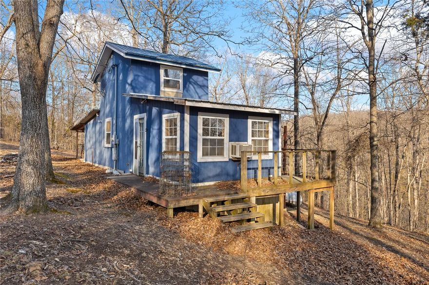 Check out this Private Cabin on 14+ acres in Newton County Arkansas! Here we have a cabin, a nice blue cabin in Marble Falls, Arkansas. Cabin features a drilled well, new tankless hot water heater, new propane gas log fire place, nice walk in shower, and private sleeping quarters in a spacious loft. 1 mile of dirt road is all that separates this place from paved Highway 7 and the renovation project that’s occurring at the areas classic premier amusement park, Dogpatch USA. Cabin is nicely located just 5 miles from the Buffalo National River and its 95,000 acres of public land and waterways to explore. Less than 30 minutes to Harrison or Jasper for any needs that could be had! This is a perfectly situated cabin for someone looking for a secluded rustic retreat. Priced to sell! Buyer to verify all utilities.