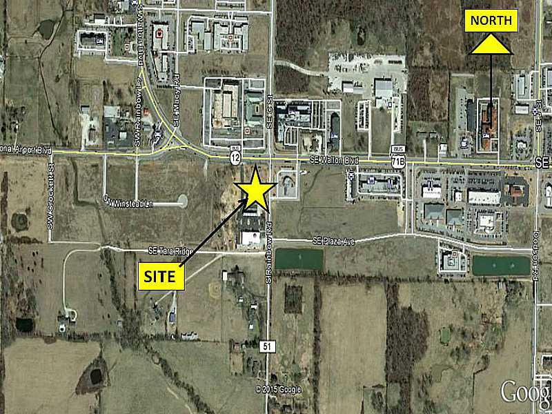 Site adjacent to "Guess Who? Liquor Store", and surrounded by various other hotel/motel, retail and commercial use properties on main thorough-fare into City of Bentonville; that being SE Walton Blvd/Hwy 71 Business and Rainbow Curve.