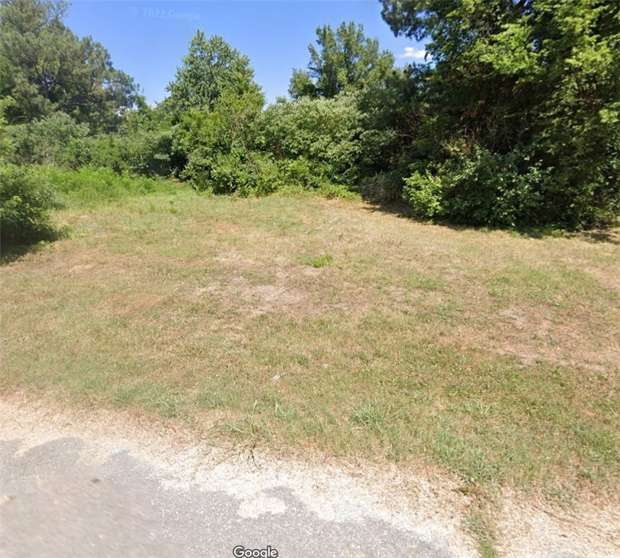 Level building lot with utilities at the street. Ready to be cleared and built on. House is of no value.