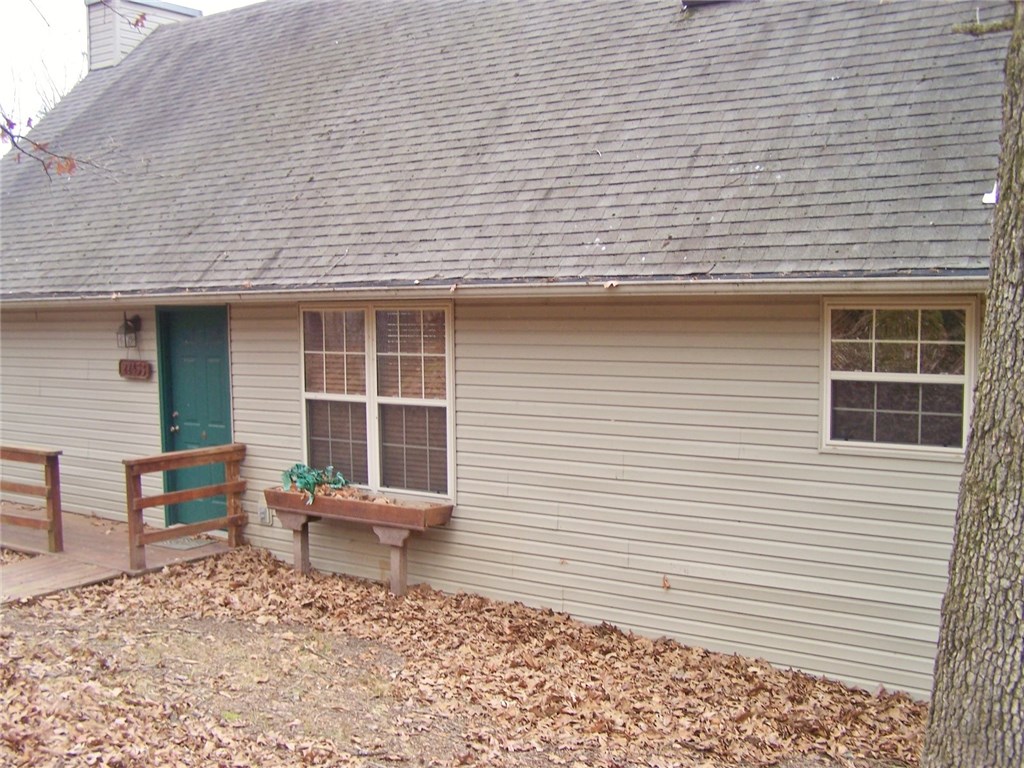 Lovely lake cottage with boat slip. Quiet semi secluded location. The back deck runs the length of the house and is the perfect spot to enjoy the outdoors and winter lake views. Upstairs loft could be extra sleeping space. Large family room with fireplace and wood floors. Spacious kitchen with pantry. Short drive to the community dock. More (and better) pictures coming.