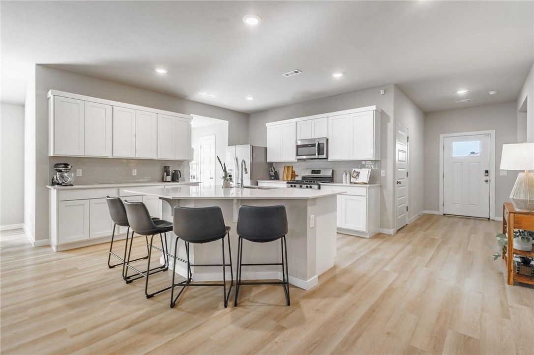 Location, location, location! Just 8 minutes from Downtown Rogers and Promenade Mall, this stunning home is better than new. It features a thoughtful split floor plan and spacious open concept living. The oversized primary suite is a true retreat, with room for cozy sitting area, a walk-in shower, double sinks, and a closet so big it feels like its own room. Tons of storage. Relax under the shade of mature trees in your park-like backyard - perfect for summer days in NWA. Fridge, washer, and dryer stay! Come fall in love- you won't want to leave.