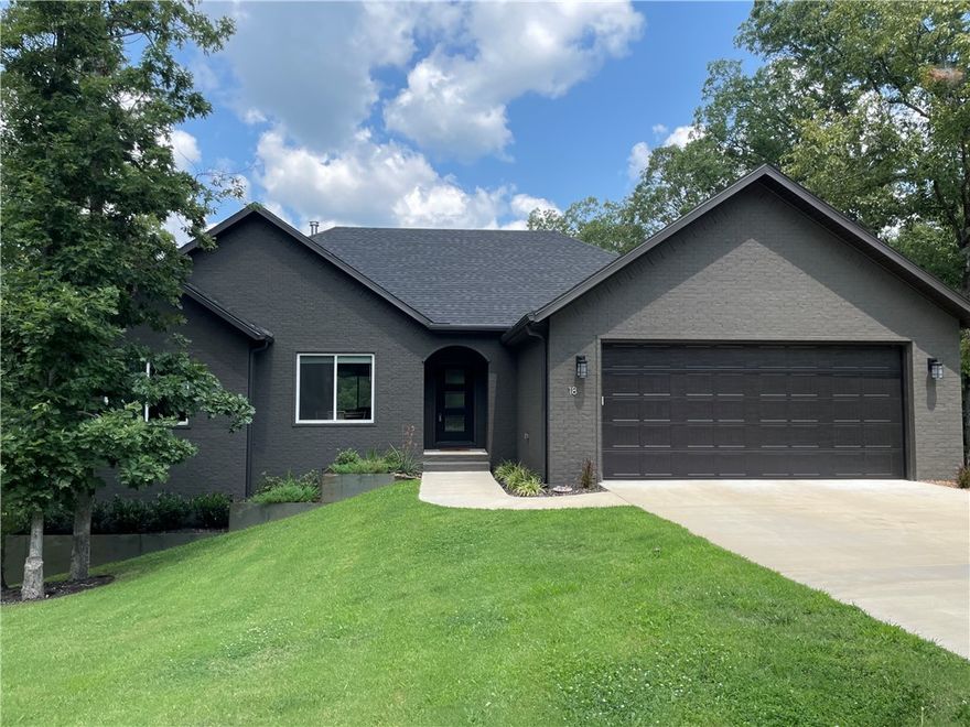 Seller to offer $5,000 credit towards buyer closing costs! Welcome to your private paradise on the Back 40, located in the Bentonville School District and just a 20-minute drive from the new Walmart Campus. Surrounded by over an acre with POA land in front and two additional lots on either side, this home offers unparalleled privacy and over $150K in exterior and interior upgrades. Home features include a walkout basement with an in-law suite or media room, a gourmet kitchen with leathered granite countertops and a gas range, and an upgraded Kozy Heat wood stove. Enjoy serene mornings from your triple-tiered decks or private hot tub with views of untouched nature. Or gather with friends around the custom fire pit. You'll also have direct access to Back 40 trails and nearby Bella Vista amenities, including Lake Ann, Metfield Golf Course, and Skills Park. Whether you’re seeking a serene retreat or a rental opportunity, this exceptional home offers the perfect balance of tranquility, adventure, and convenience.