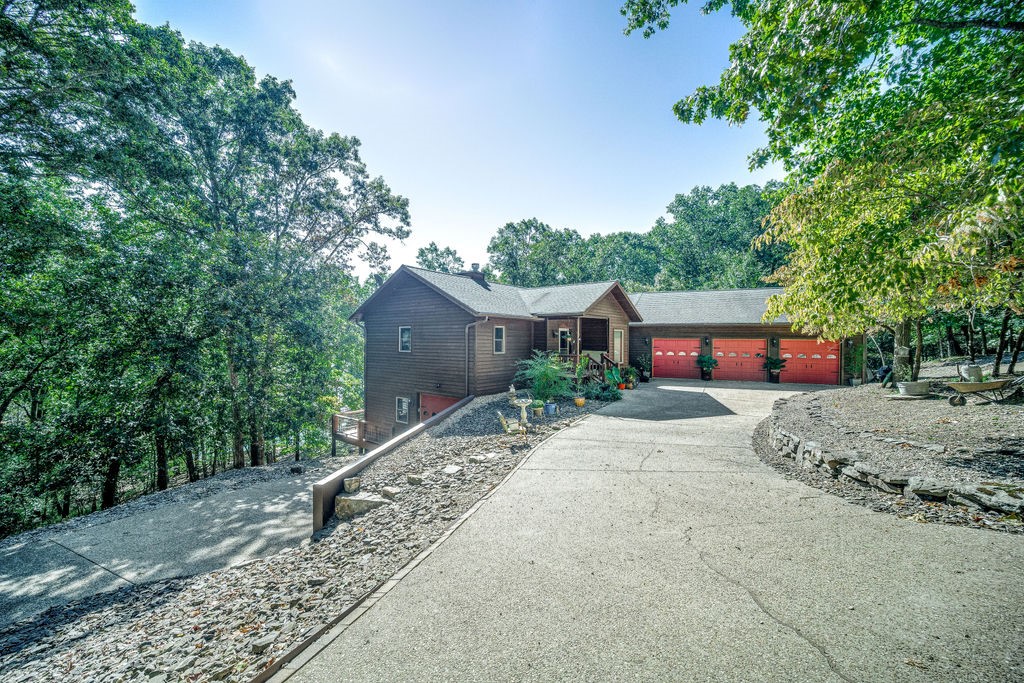 Wow! This is the one you have been waiting on!! Lake front home tucked in a wide deep cove, it has all the things! Superb lake appeal from the time you drive onto a private 8.4 acre wooded lot. From the living room experience soaring vaulted ceilings, wide plank oak hardwood floors, updated kitchen, and lots of windows to enjoy the views Beaver Lake. There are lakeside decks on both the main level and basement level. Two en-suite master bedrooms on the main level, and downstairs you will find the third and fourth bedrooms, family room, kitchen, and loads of storage. Private 1 slip (10x24) dock at the shoreline. Located at the north end of Beaver Lake, known for the jumping rock, and beautiful water clarity.