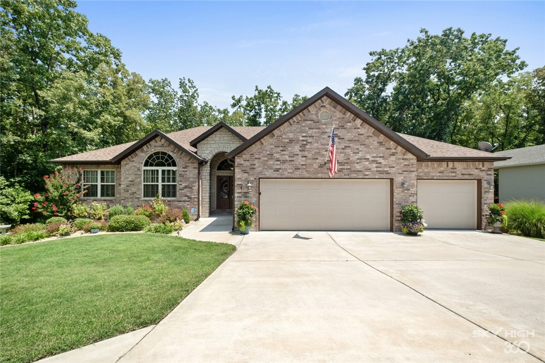 Welcome home to this amazing spacious family home in Bella Vista. Hop on the BACK 40 MTB trail from your back yard. Beautifully landscaped with custom fire pit area. Open concept eat-in kitchen with large island, walk-in pantry and farm sink. Cozy up to the fireplace in the living room and enjoy the view. Master bedroom with ensuite full with walk-in shower and soaking tub. Upstairs includes dedicated office space and additional bedroom and bathroom. Downstairs enjoy the extra space in the media room. Two large bedrooms and a full bath downstairs. Walk-out basement great for grilling. Over-sized three car garage with additional workshop space.