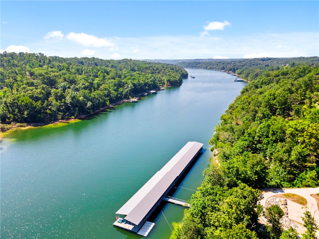 Welcome to Hawks Landing, one of Beaver Lakeās most sought-after lakefront communities. This rare, flat lot spans over two acres and offers the perfect canvas for your dream home. Once cleared, the property will reveal breathtaking scenic views of the Ozark hills, creating a private retreat that blends luxury and nature.
Surrounded by multi-million-dollar estates, this neighborhood embodies both prestige and serenity. Residents enjoy a sense of privacy and peace, while still being part of a select, sought-after enclave.
The property includes a 28' boat slip and a jet ski slip at the community dockācomplete with a swim platform and sundeckāso you can embrace lake life from day one. Whether youāre enjoying sunrise coffee overlooking the woods, entertaining with sunset cruises, or simply soaking in the stillness of the Ozarks, this homesite offers it all.
Build your vision here and become part of one of the most coveted addresses on Beaver Lake.