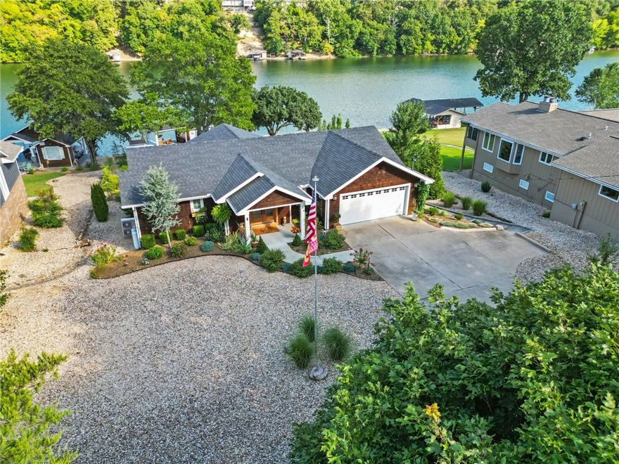 Welcome to luxurious serenity nestled on Bella Vista’s largest lake.On a gentle sloping lake front lot,this “Nantucket on the Lake” home has been meticulously updated to the highest standards. The exceptional quality is evident in the custom built-ins,leather-topped primary bedroom cabinets,reclaimed white oak floors,quartz counters,& custom finishes.Main level boasts panoramic views of the glistening lake, spa-like primary bedroom/ensuite, open-concept kitchen w/high-end Café appliances, & motorized custom shades.The walk-out basement offers a 2nd bedroom, sleeping nook, full bathroom w/clawfoot tub, & spacious bonus room.Savor the lake lifestyle on one of 2 decks, sip a cold drink on your porch swing overlooking the lake,or catch the Hog game on your boat house dock- complete with ample seating & flatscreen TV. Featured on a national home remodel show, this stunning lake home is unmatched in quality & style. Fish on the dock, cruise the lake on the pontoon-don't miss this opportunity to seize the day- Carpe Diem!