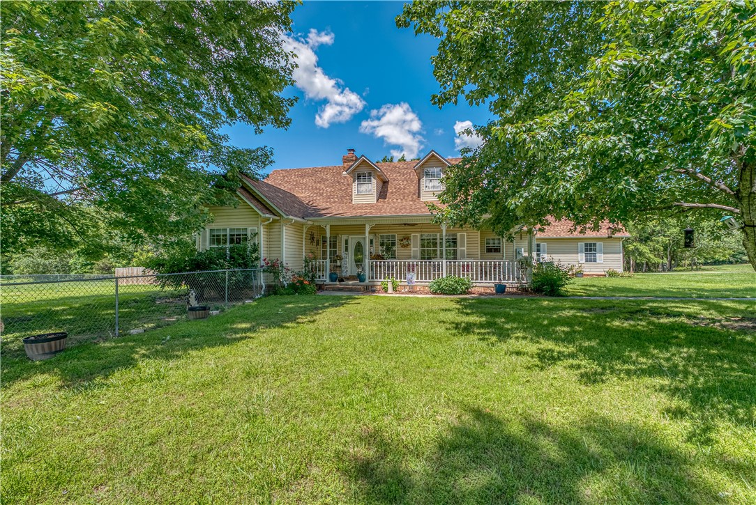 Discover peaceful country living with this 3 bedroom. 2.5 bath home on 5.84 acres! It's in a great location-just minutes from town and only about 30 minutes to Branson MO. The home has a welcoming feel with a wood burning fireplace in the cozy living room, and a huge patio that's perfect for grilling, relaxing and entertaining. The covered front porch is a great spot for morning coffee or watching the sunset. One of the highlights is the huge master bedroom, complete with its own kitchenette area-great for extra convenience or even private guest space! There is a unfinished heated basement area with garage doo , giving space for storage or workshop, a storm shelter that you can enter from the master bedroom, and storage space in the attic. If you enjoy country living with room to breathe-but still want to be close to town-you will want to take a look at this home!