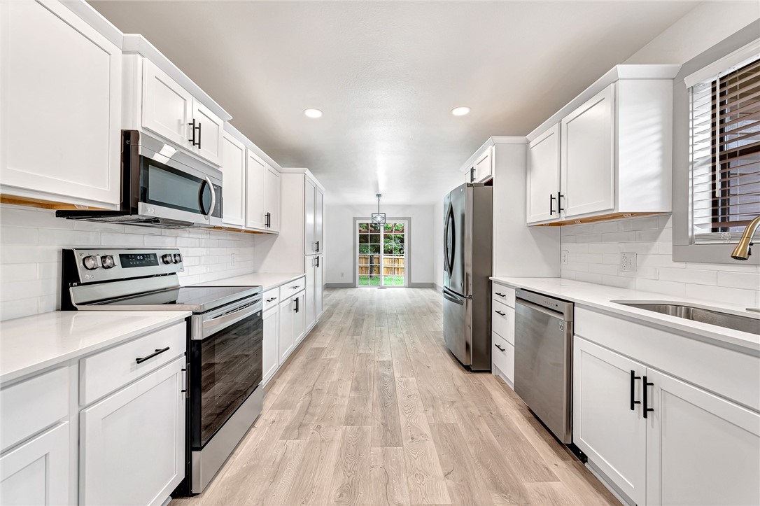 Welcome to this stunning 3-bed, 2-bath completely remodeled home on a large corner lot. Updates include a new roof, gutters, HVAC, water heater, cabinets, flooring, and quartz counters; every detail has been perfected. Step into the modern elegance and functionality of this tastefully updated residence. You will love the oversized living room with wood burning fireplace! The kitchen features pristine cabinets with soft close doors and drawers, while the quartz counters and open layout make entertaining a breeze. The bedrooms offer comfort and privacy, while the remodeled bathrooms feature sleek fixtures and stylish tile work. Outside, the landscaped yard with a fully screened porch and private backyard provides a peaceful retreat for relaxation and entertainment. Located in a desirable area with convenient access to amenities, shopping, and bike trails; this home is ready to enjoy. Don't miss out on the opportunity to make this exquisite remodeled gem yours. Schedule a showing today!