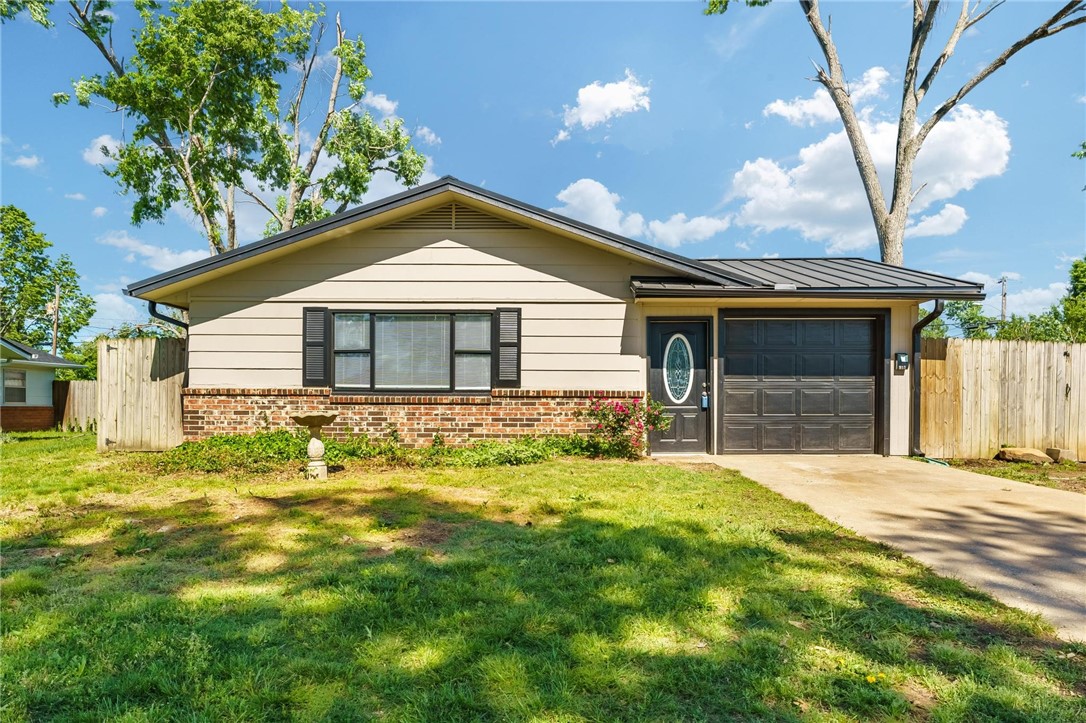 Great location! Right down the street from paved walking and biking trails. Close to the heart of Downtown Rogers and Railyard Park. This 3 bedroom house has fresh paint and all solid surface floors. Metal roof. New gas range and new refrigerator. New blinds. Updated HVAC. Also included washer and dryer. The yard is large and has a wood privacy fence with drive in gate from the side street. Also included are 3 storage buildings that altogether have about 300 sq ft. Plenty of room to play and have some great gardens.
