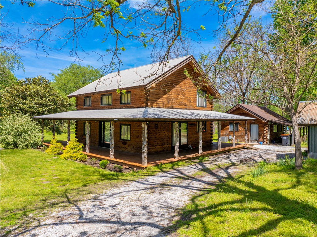 Tucked away on over 3 private acres, this charming log cabin offers rustic character and peaceful seclusion just off Highway 45. The 1-bed, 2-bath layout includes a loft-style bedroom that can be converted to 2 bedrooms, spacious open living area, and a mix of wood and concrete flooring for durability and warmth. Also included is a detached studio—ideal for guests, a home office, or creative space. Enjoy serene views from the wraparound porch, perfect for relaxing or entertaining. The level, lightly wooded lot provides a blend of sun and shade with room to explore or expand. Located in a quiet neighborhood with upscale homes, easy access to town, this is a rare opportunity to enjoy a peaceful retreat without sacrificing convenience!