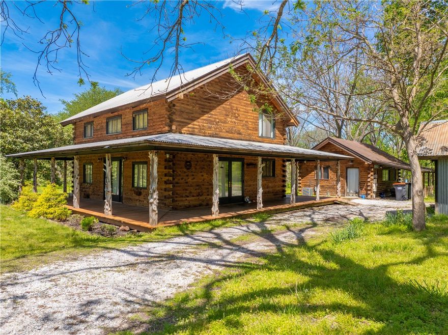 Tucked away on over 3 private acres, this charming log cabin offers rustic character and peaceful seclusion just off Highway 45. The 1-bed, 2-bath layout includes a loft-style bedroom that can be converted to 2 bedrooms, spacious open living area, and a mix of wood and concrete flooring for durability and warmth. Also included is a detached studio—ideal for guests, a home office, or creative space. Enjoy serene views from the wraparound porch, perfect for relaxing or entertaining. The level, lightly wooded lot provides a blend of sun and shade with room to explore or expand.  Located in a quiet neighborhood with upscale homes, easy access to town, this is a rare opportunity to enjoy a peaceful retreat without sacrificing convenience!