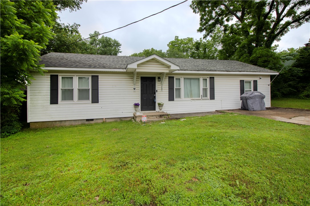 Attention investors! This adorable cottage for under 200k is just a stone's throw from the cute shops and cafes in downtown Prairie Grove. Enjoy the fully enclosed spacious flat backyard, and the flexible floorplan, featuring 2 bedrooms, and 2 additional bonus rooms. Hardwood floors in the living and bedrooms. Likely cash or in-house financing.