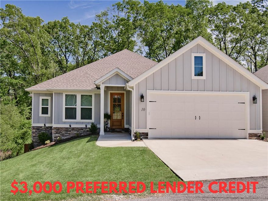 Welcome to this impeccably maintained home built in 2023, offering breathtaking wooded views! Sewer lot! Situated just down the street from the Uphill Both Ways Trail Crossing and within very close proximity to Lake Windsor, Lake Avalon, Tanyard Creek, and the OZ Bike Lift. Step inside to discover beautiful hardwood floors throughout, including in the primary bedroom and guest bedroom / office. The primary bath boasts a luxurious soaking tub, a spacious custom tile shower, and an expansive closet for all your storage needs. 3 bathrooms! Enjoy the grandeur of cathedral ceilings in the living and beautiful custom cabinets in the kitchen, complete with a large pantry. Laundry room is massive and features tons of cabinets and a sink. The home is adorned with custom finishes throughout, enhancing its appeal. Relax on the huge covered patio with a wood ceiling or utilize the extensive storage space below the home. The fenced-in backyard offers privacy and plenty of space for outdoor activities. Bentonville schools!