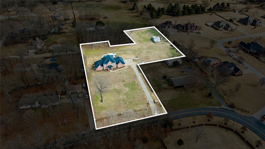 WELCOME HOME!! Spectacular Custom-Built Estate Home nestled on 2.82 Private Acres with Pool, Barn and Gated Entrance. Incredible location with easy/quick access to I49, 8th Street, Downtown Bentonville, and the New Walmart Home Office Campus. Completely remodeled gourmet kitchen (2023) with custom cabinetry, Large Island, Quartz countertops, double fridge, white farm sink and gas cooktop with Pot Filler. Luxurious Master suite with vaulted ceiling, double sided fireplace, separate sitting area with fireplace, private walk out deck, wet bar including ice maker and wine fridge.  All secondary bedrooms with their own private bathrooms  Lots of possibilities for the newly constructed apartment/STR(located Over the 4 Car Garage) complete with kitchenette, laundry facilities, it's own entrance and a mini-split HVAC. Meticulously maintained home with New roof and gutters in 2021, composite decking, new tankless water heater with recirculation pump, 3/4 inch real hardwood floors, Yard irrigation and more.