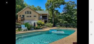 3BR 2.5BA home with amazing lake view, located in the Webbs Landing Subdivision. Home features open floor plan, river rock fireplace, in ground salt water pool, family room in the basement with wet bar. 30x40 detached garage/workshop that includes a 450 sq ft apartment. Comes with a boat slip in a community dock just short drive from the house. AirPark with grass strip less than a mile from the house, has room for more hangers. Amazing property with a lot to offer.