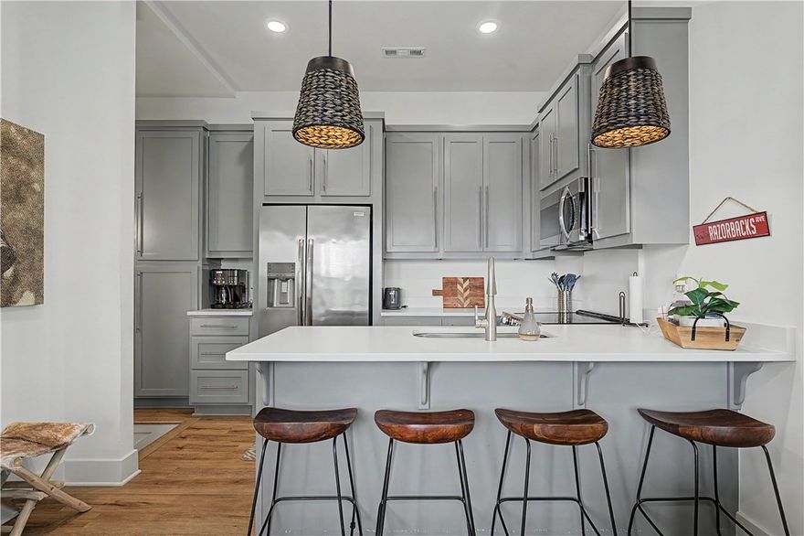 Fantastic 2 bedroom, 2 bath South Hill Avenue townhome in the perfect location! This gorgeous townhome is just minutes from U of A, Razorback Stadium, Dickson, walking trails, bike trails, shopping and so more more! A beautiful kitchen fit with a Frigidaire Appliance package that includes an oven, range, microwave and refrigerator, quartz countertops, and ample storage. Laundry room with stackable washer and dryer, luxury vinyl plank flooring and ceramic tile. Large bedrooms and beautiful bathrooms, also includes your own private balcony! Comes with two designated parking spaces. Selling it fully furnished! This townhome has everything you need. Perfect home or investment!
