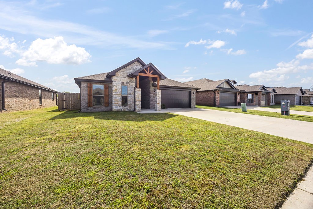 Motivated Seller! The upgrades have been completed for you! This stunning Bentonville home offers comfort and modern convenience. Step inside to high ceilings, large windows, and a cozy fireplace for picturesque holidays. The open living space centers around a beautiful kitchen featuring matching Frigidaire Gallery appliances and a coffee bar upgrade for more countertop and cabinet space. To maintain the kitchen’s sleek look, the refrigerator conveys. The large primary bedroom provides a peaceful retreat with a luxurious en-suite bathroom, highlighted by upgraded marble slab shower walls and a sleek frameless glass door. Smart home features such as a smart thermostat, smart garage door opener, and USB equipped kitchen outlets enhance your daily living, while upgraded ceiling fans add year-round comfort. Enjoy relaxing or entertaining on the covered patio. Just a minute's walk from the neighborhood dog park. Schedule your showing today!