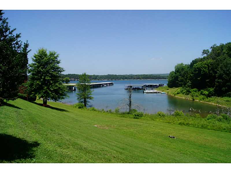 Gracious lake front living in well apportioned lower unit and one of the larger floor plans. Lake view from most rooms, large patio with access from master, guest and living room. Wood burning fireplace for those chilly nights as well as wet bar. Also,has detached garage and boat slip! You need to see this.