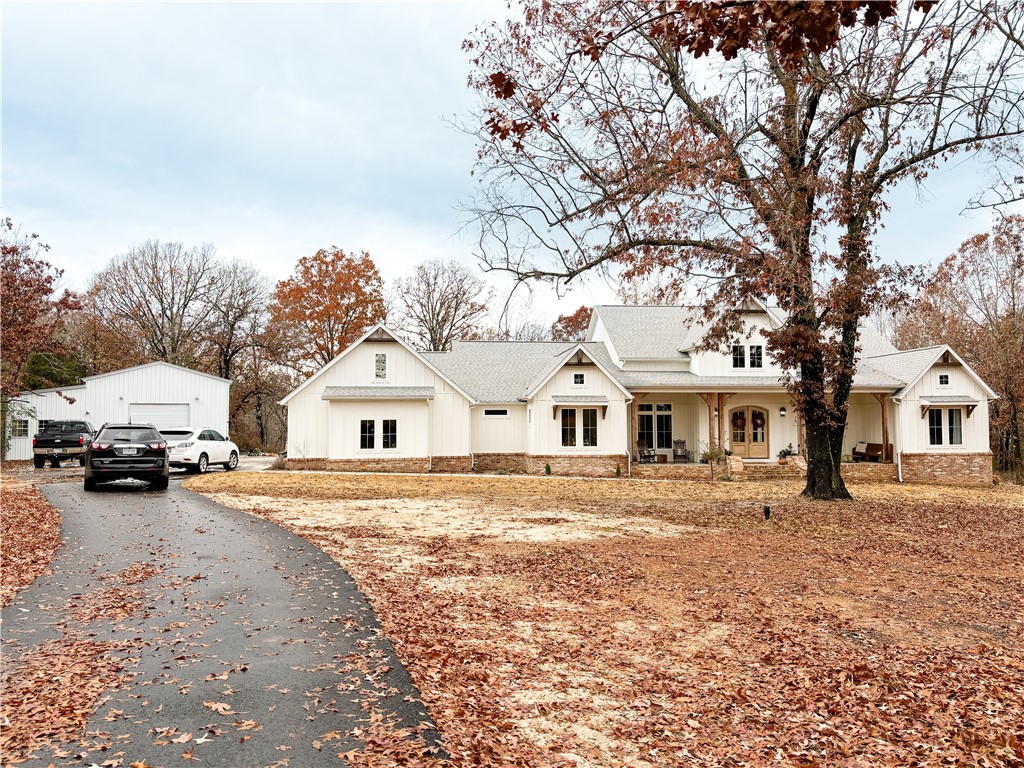 Nestled in a tranquil park-like setting, near a pond and 12 acres of wooded trails, this exquisite 4-bedroom, 3.5 bath home blends modern luxury with timeless charm. Boasting an open-concept layout, the kitchen space allows you to enjoy a large space. The master bedroom is spacious and the master closet is just as big. The shop building is 30x40 which 300 sq feet is heated and cooled with its own fully functional bathroom that you can Airbnb or use for guests. The yard is cleared, but the land is full of trails, woods, and hunting.
Antique brick, Zellige Tile, Pond, Privacy, Custom, 22' Ceilings, Limestone Fireplace, Wood Beamed Ceiling, Outdoor Fireplace, Quartz Countertops, Brass Fixtures, and more.