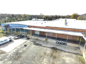 This 49,000+ sqft Industrial warehouse is located close to the interstate and is dock height. The main warehouse is 24,000 sqft with covered offloading bay at dock height. There are 5 separate bays feeding into the main warehouse section ranging from 3,600 sqft to 5,000 sqft. This property is located next to the Rail Road and at one time had a spur. Ideal location for your Business.