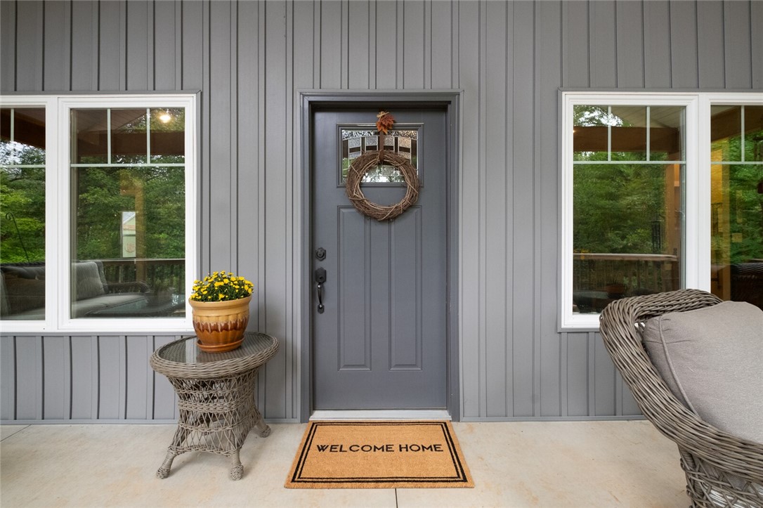 Welcome to the Hodge Lodge- where your homestead dreams become reality. You will love the private 5-acre nature setting of this 2020 home. Sit on the front porch with your coffee and watch the hummingbirds, deer and the rest of nature come to life. After a day of foraging for wild morels & blackberries (just to name a few) or front entry garden, take a relaxing soak in the primary's claw foot tub. Warm up this winter by the fireplace with a good book from the library built-ins. Meals are a breeze in the open kitchen with large island. Step out back to the bird habitat for those fresh eggs. For the young- or young at heart, take a tree covered stroll to the fairytale tree house with climbing wall. Shop is perfect for your next project or added storage, though the oversized garage provides plenty of extra space. For security you will love the peace of mind with the built-in storm shelter and generator hook up. All wrapped in this nature loving home. Only 15 minutes from I49. Come and see!