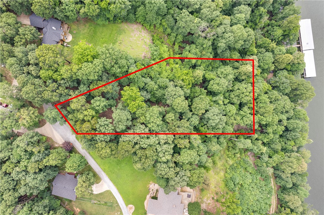Build your dream lake retreat on this stunning 1.63-acre lot overlooking beautiful Beaver Lake. Enjoy breathtaking views, peaceful surroundings, and direct lake access with your very own boat slip, with a lift included. Whether you're planning a full-time residence or a weekend getaway, this rare opportunity offers the perfect blend of nature, privacy, and water recreation. Utilities are already at the street to accelerate your construction timeline. Don't miss out on one of the few remaining parcels with a boat slip and panoramic views! Check out MLS #1311918 for both parcels (2 boat slips and 3.6 acres) and MLS #1312086 for the home.