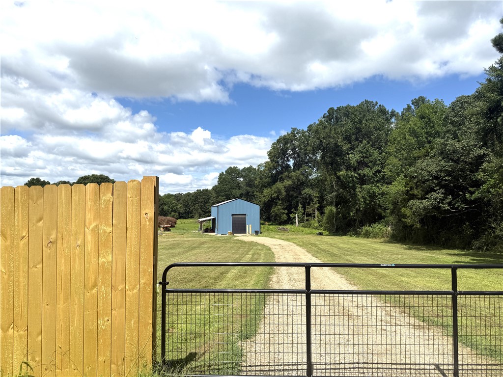 Discover the perfect blend of convenience and privacy with this unique 9 acre property located just minutes from I-40 in Lamar. Tucked away for peace and seclusion, this versatile property features a spacious shop with comfortable living quarters inside, ideal for a fulltime residence, weekend retreat, or base for your business or hobby. The land is fenced and includes a barn, making it ready for horses, livestock, or other animals. A cleared pad is already in place, offering the perfect spot to build your dream home while you live on-site. Enjoy having fast access to the interstate and local amenities, with the serenity of country living. Whether you're looking to homestead, invest, or simply enjoy the quiet life with room to grow, this property checks all the boxes