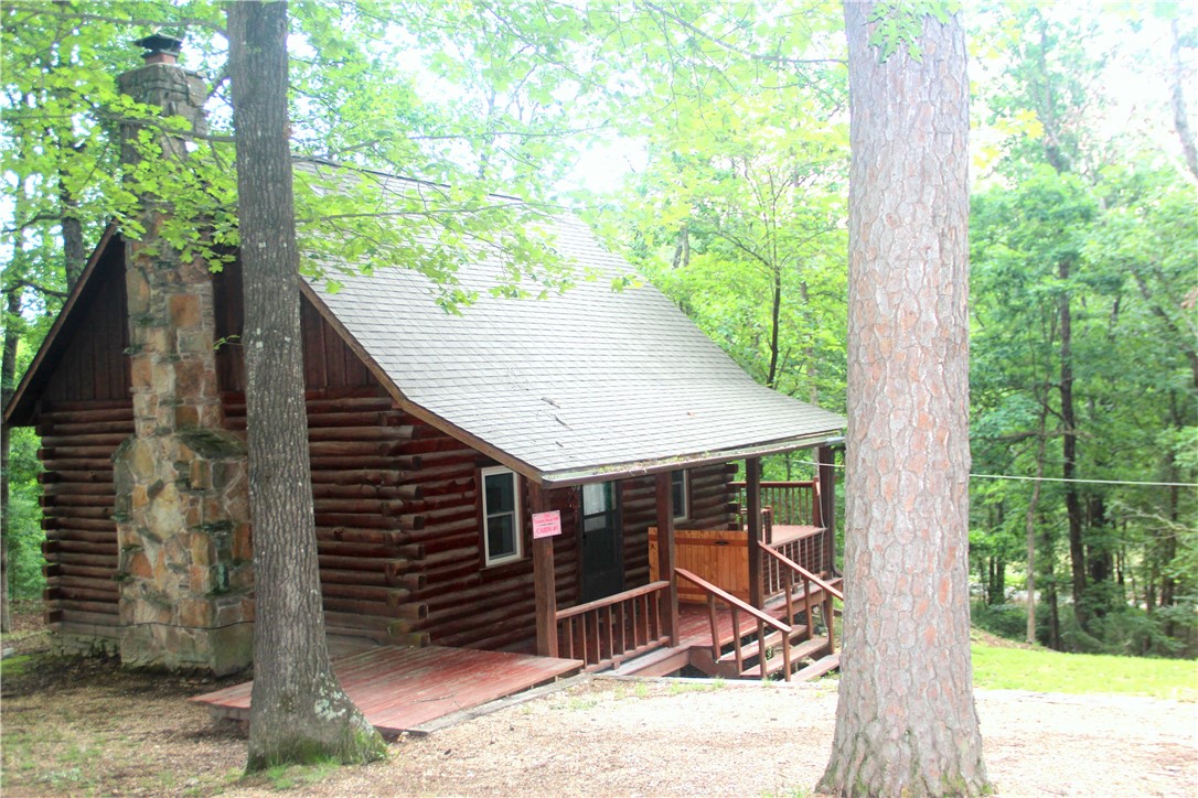 A Charming 720 Sq. ft. Log Cabin located on the Shores of the one of 2 private fishing ponds in the Redbud Valley Common area.
The Cabin is a 1 Bedroom with a loft and 1.5 baths. Wood burning Fireplace, 800 sq ft of Decks nestled in the woods and fire pit create a natural outdoor living space.
The Private Red Bud Valley community Common area consists of walking trails, gardens, 2 fishing ponds and playground area. 5 minutes to Beautiful Eureka Springs AR, 15 minutes to Kings River Trigger Gap and the river outfitters and the Arkansas Game and Fish 15,000 ac game refuge.
The Cabin can be used as a VRBO.