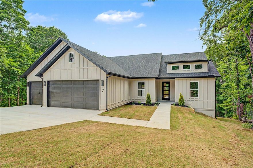 Discover a beautifully designed new construction home offering 3 bedrooms, 2 bathrooms, a dedicated office, and approximately 2,170 sq.ft. of thoughtfully curated living space. Featuring 10' ceilings and luxury vinyl plank flooring throughout, the home blends modern style with everyday functionality. The open-concept living area showcases a custom fluted tile fireplace surround, while the kitchen boasts black granite countertops, stainless steel appliances, soft-close cabinetry, pop-up island outlets, and a large hidden walk-in pantry. Custom built-ins throughout the home add character and practicality. The spacious primary suite offers a relaxing retreat complete with a soaking tub, tiled walk-in shower, and oversized walk-in closet. Additional highlights include a 3-car garage and a split layout ideal for a variety of lifestyles. A wonderful opportunity to own a move-in ready new construction home in Bella Vista with elevated finishes throughout.