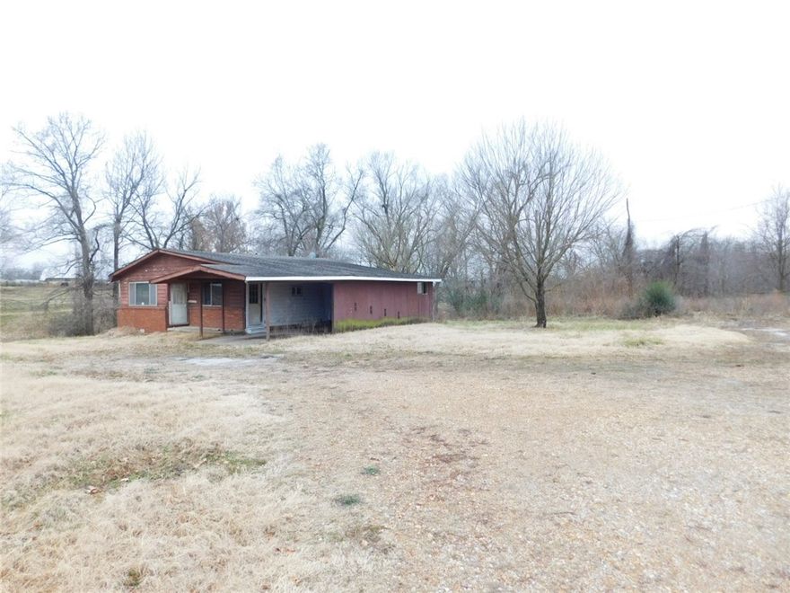 Located on one of Pea Ridge's most traveled roads.  Great commercial potential.  The new Walmart Supercenter is to be built right down the road.  A new subdivision and commercial businesses are to the south and back up to this one acre.  Electric on site.  Gas, water and sewer available.  Call the city to inquire about availability.  The house on the property has no value.
