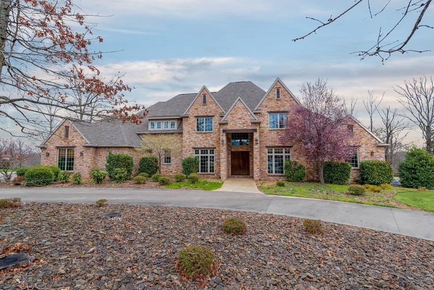 You will be enamored with the brick and iron accents of the formal dining and executive office. Stained concrete flooring leads to the grand formal living space with iron railed arches overlooking from the second story. The great room boasts of a beautiful chefs kitchen with huge granite island and upscale appliances and is open to a large living room with fireplace and built ins, and overlooks the pool and veranda. Master suite with private entrance & coffee bar, 2nd office, and stunning master bath space. Too many extras to list, must see!