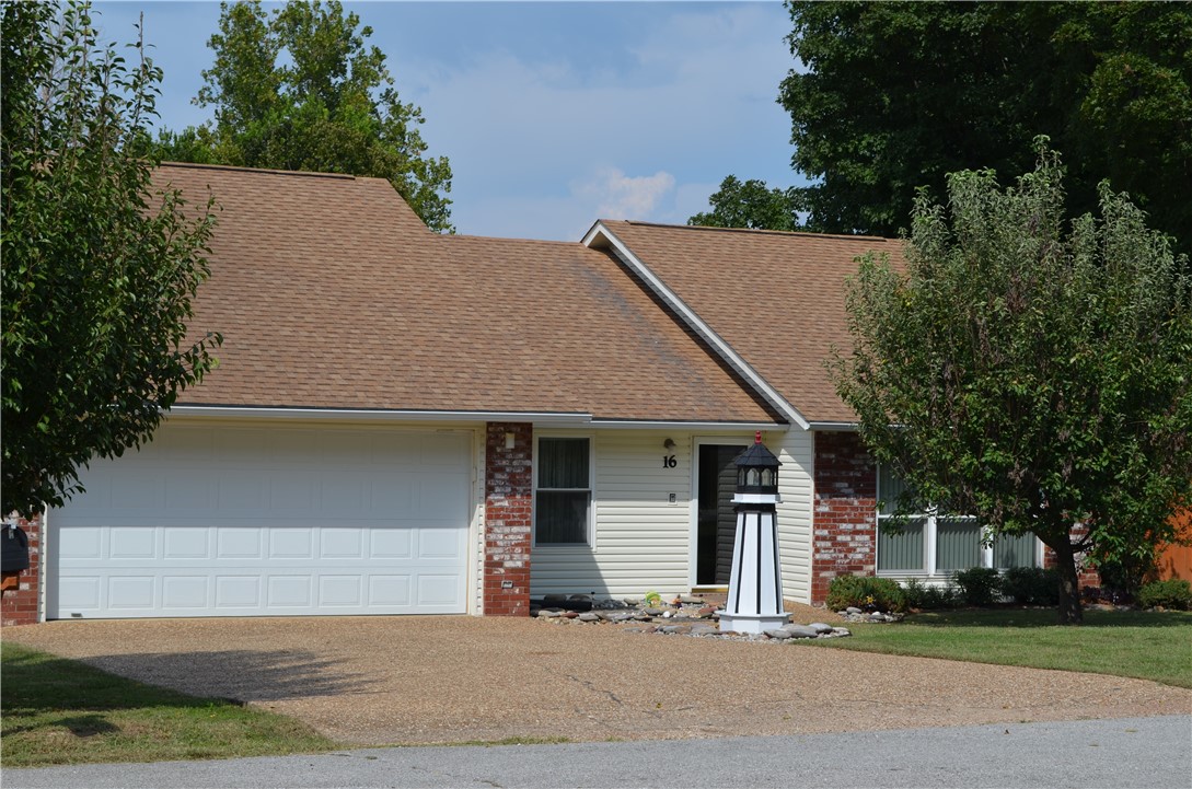 This 1,492 square foot, three-bedroom, two-bathroom, two-car garage home has been perfectly maintained. Move-in ready! Front door complete with storm door faces the South. Located in the city limits near shopping, banking, dining, and just around the corner to Seven Brew! First turn off of Hwy 62 on a paved, quiet, dead-end street. Updated vinyl windows. Hardwood, carpet, tile and Tarkett floors. Tile and cultured marble countertops. Solid oak kitchen cabinets. Instant hot water to kitchen sink. Remote control awning that senses wind speed and automatically retracts when the wind speed is too strong. Extra reinforced patio sufficient for the weight and placement of a possible hot tub purchase. Garage Door Opener. Heat Pump Electric Water Heater. Trane Heat Pump Central Heating, Ventilation and Air Conditioning. Roof replaced in 2009 with 30-year shingles. Water and electric utilities. Double gate on either side of the backyard fence. Fruit tree, pear and green apple.