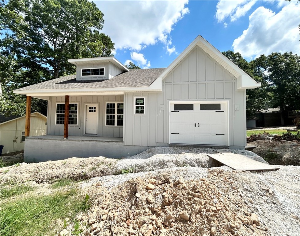 Discover this stunning new construction home located down the street from the Back 40 Trailhead and provides easy access to downtown Bentonville. This exquisite home sits on a .29 acre wooded lot and boasts high-end finishes throughout! Step inside to find a stylish open-concept layout, adorned with wood floors. (no carpet) Beams in living room! The focal point of the home is the kitchen, equipped with custom cabinets, a wood hood, luxurious countertops, & a large kitchen island. You'll love cooking with premium stainless steel appliances, including a gas range. Retreat to the primary bath, where you'll find a spacious walk-in tile shower & double vanity. 2 bedrooms / 2 baths. Close to Lake Rayburn and Metfield Golf Course. Plus, take advantage of $3,500 in buyers closing costs, courtesy of the builder's preferred lender! Approx completion date - 9/5/25. This home is eligible for RD financing (no down payment).